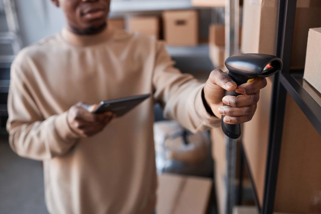 focus-on-hand-of-young-man-holding-scanner-by-one-2023-11-27-05-30-10-utc (1) The Role of Inventory Management in Small Business Success myStock TallOrder TallOrder POS Retail Features Barcode Scanning